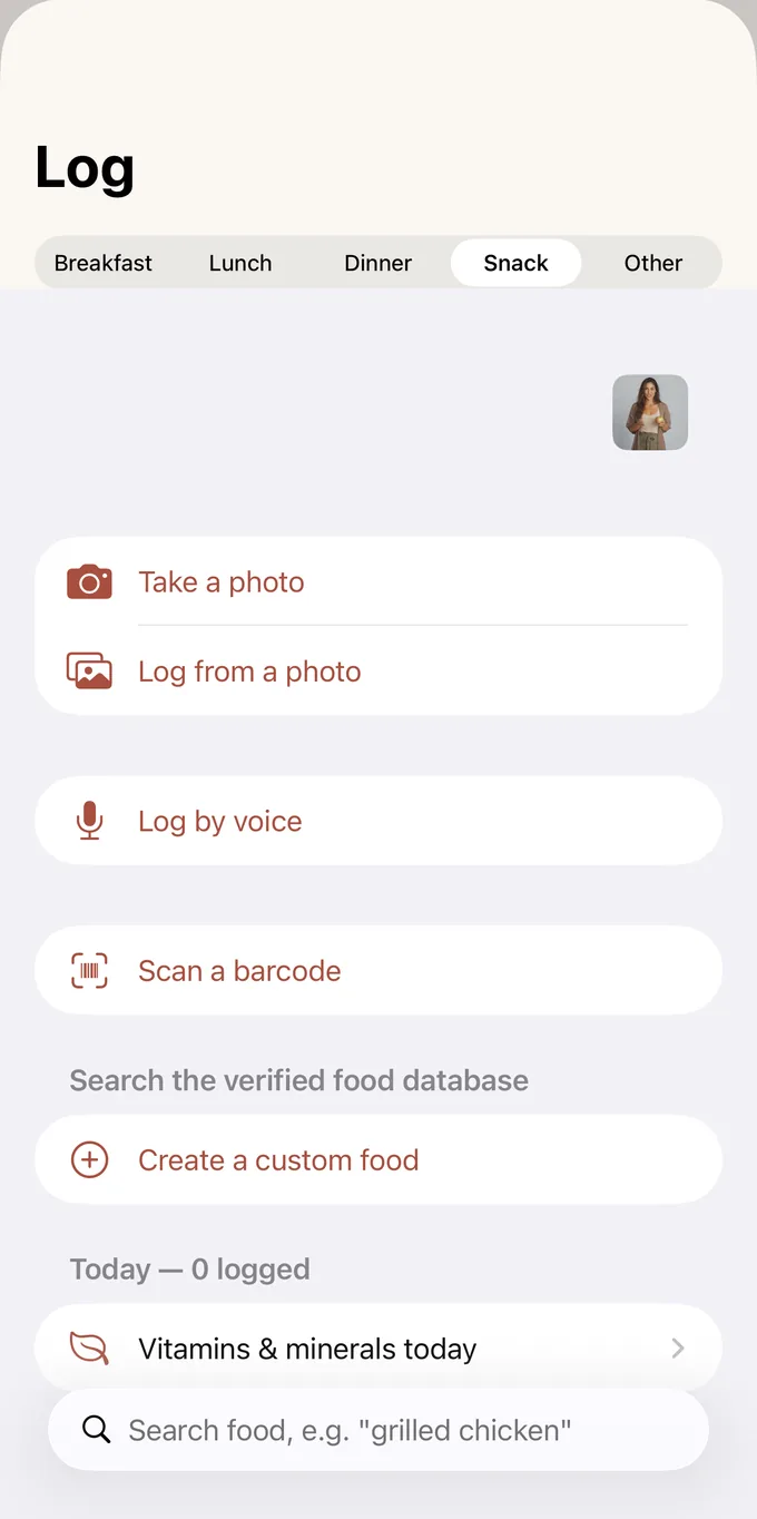 The Koydo Life logging screen offering four ways to add a meal: take a photo, log from a photo, log by voice, or scan a barcode, above a search box for the verified food database.
